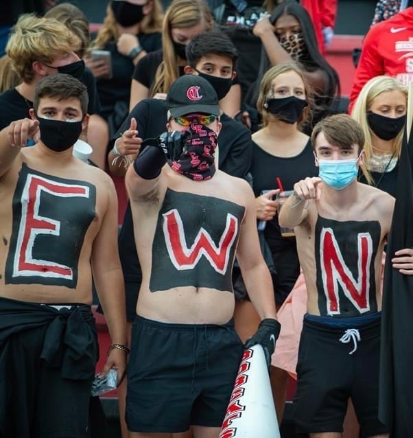 Bryson Richie, pointing at the camera,  and fellow seniors at a Central High School football game.