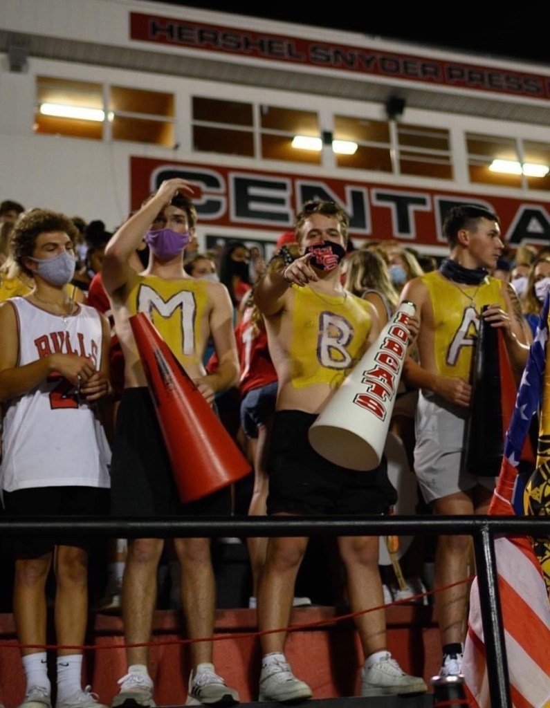 Bryson Richie cheers on the Bobcats at a football game. 
