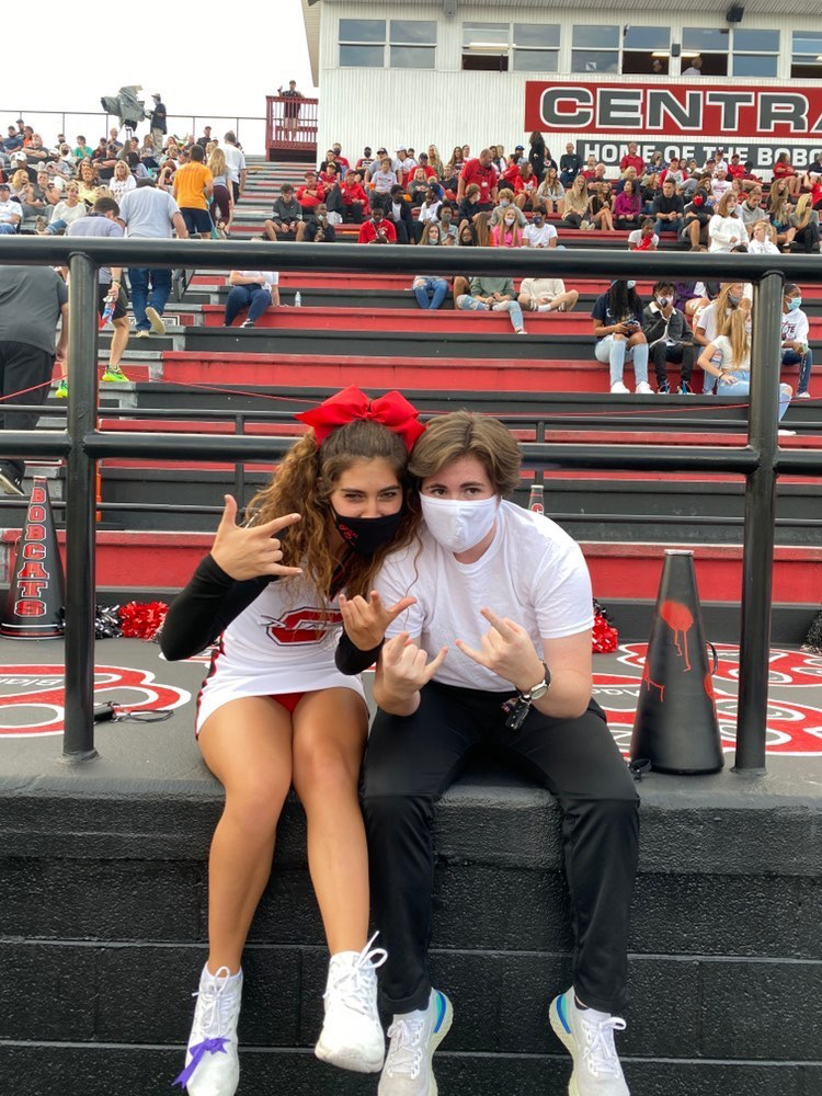 Ella Wilds and Berkeley Bowers posing for a photo at a Central High School football game. 